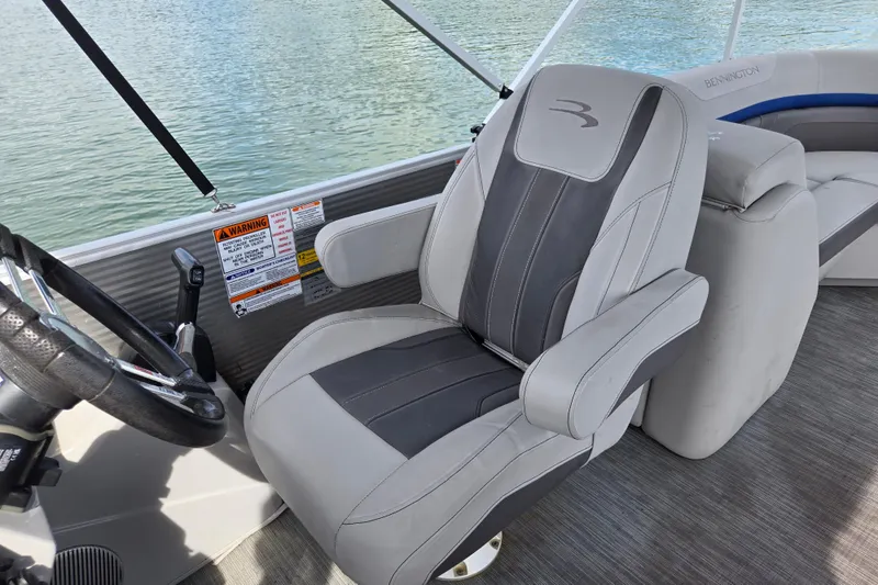 Slide: The Image of Captain's chair on 2023 Bennington 22 SSR pontoon boat, overlooking water. - 16