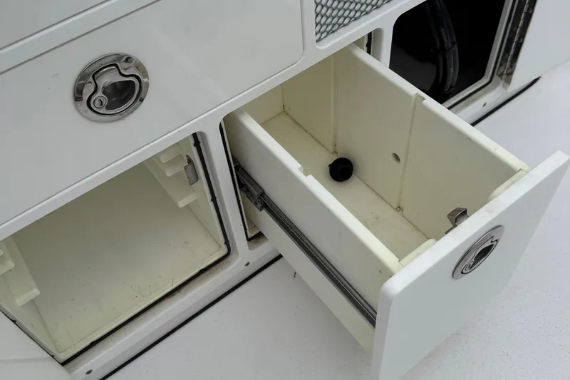 Slide: The Image of Open storage compartments on a 2020 Sportsman Open 282TE Center Console boat. - 23
