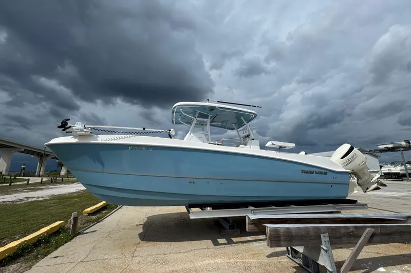 The Image of 2021 Twin Vee 280 CC GF boat on trailer under cloudy sky. - 0