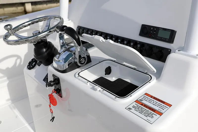 Slide: The Image of Manufacturer Provided Image: 2021 Twin Vee 280 CC GF boat console with steering wheel, controls, and storage compartment. - 11