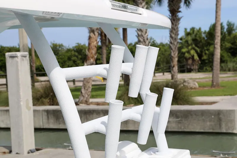 Slide: The Image of Manufacturer Provided Image: Rod holders on a 2021 Twin Vee 280 CC GF boat, docked near palm trees. - 12