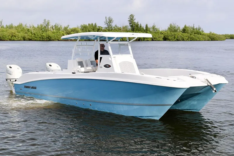 Slide: The Image of Manufacturer Provided Image: 2021 Twin Vee 280 CC GF boat cruising on a calm lake. - 2