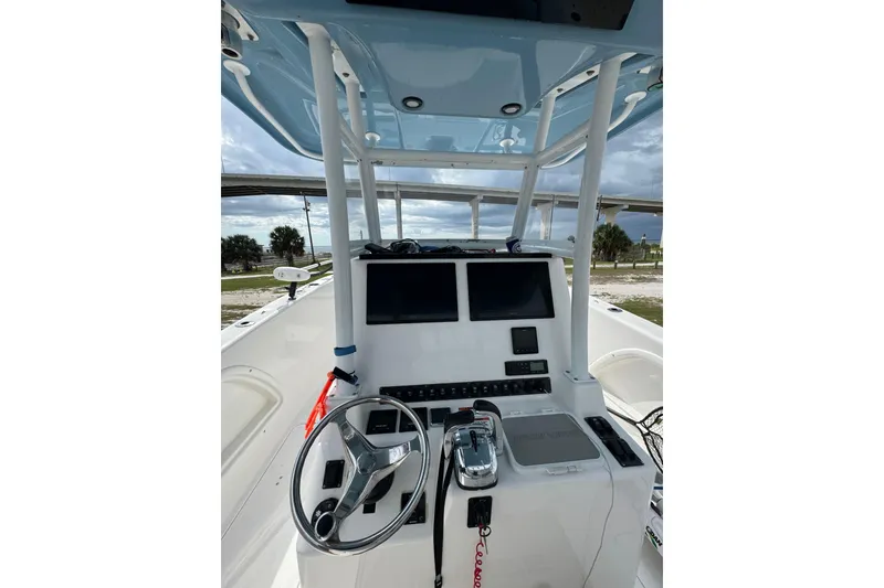 Slide: The Image of 2021 Twin Vee 280 CC GF boat console with steering wheel and dual screens. - 27