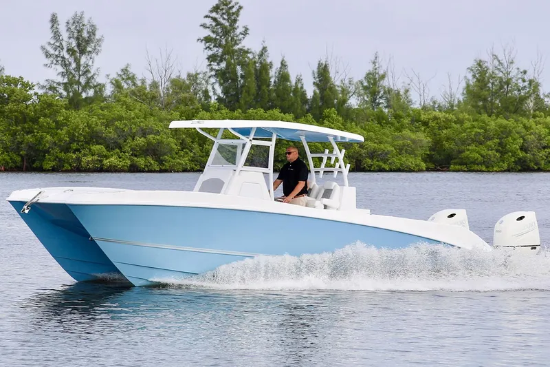 Slide: The Image of Manufacturer Provided Image: 2021 Twin Vee 280 CC GF boat cruising on a calm lake. - 3