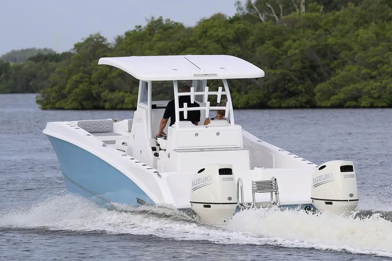 Slide: The Image of Manufacturer Provided Image: 2021 Twin Vee 280 CC GF boat cruising on a river with twin Suzuki engines. - 4