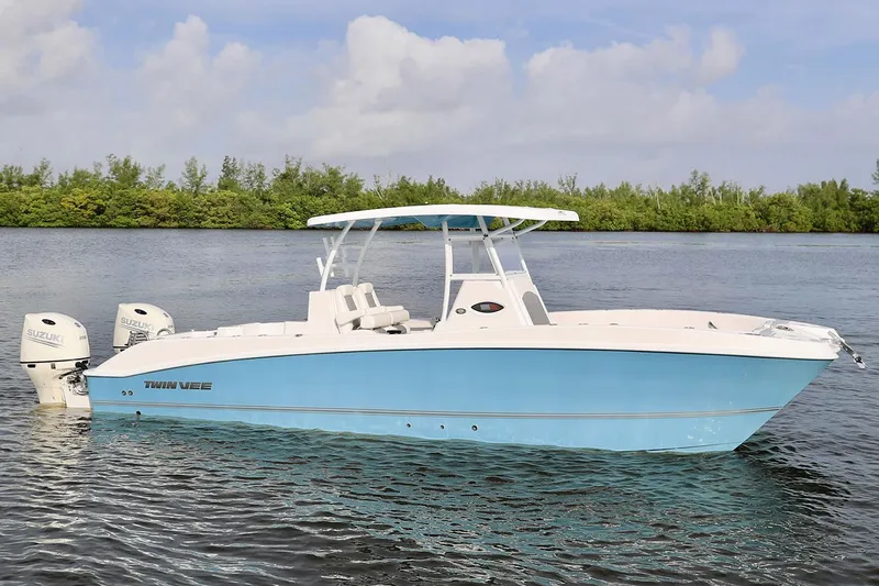 Slide: The Image of Manufacturer Provided Image: 2021 Twin Vee 280 CC GF boat on calm water with lush green background. - 5
