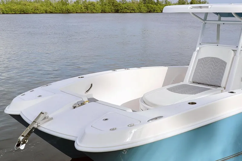 Slide: The Image of Manufacturer Provided Image: 2021 Twin Vee 280 CC GF boat on calm water with lush green background. - 6