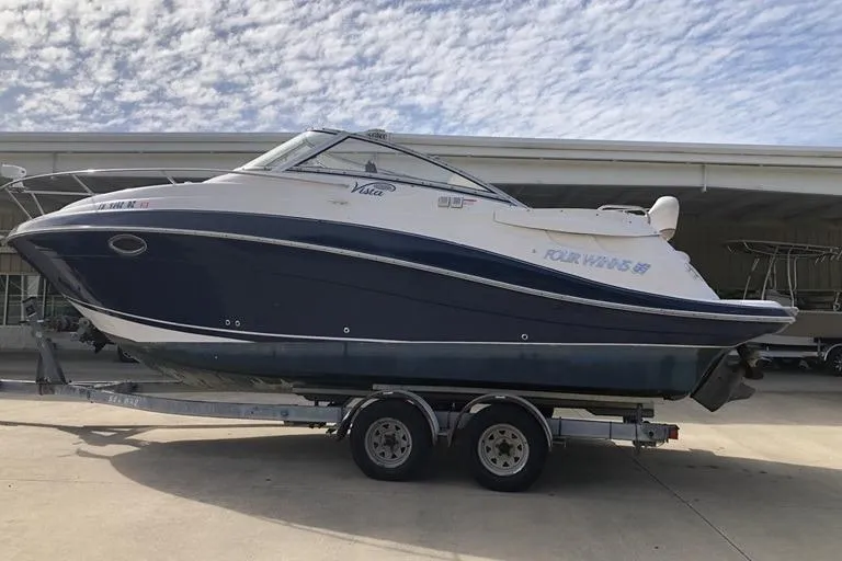 The Image of 2006 Four Winns 258 Vista boat on trailer under cloudy sky. - 0