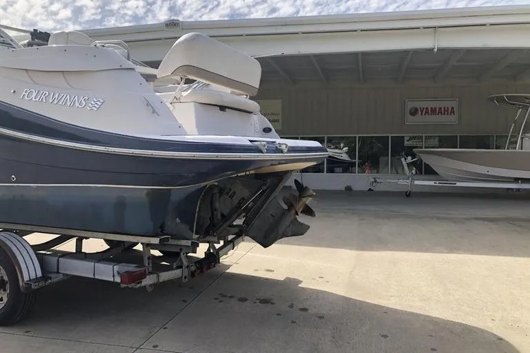 Slide: The Image of 2006 Four Winns 258 Vista boat on trailer, parked outside a Yamaha dealership. - 1