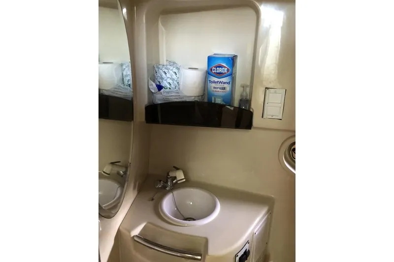 Slide: The Image of 2006 Four Winns 258 Vista boat bathroom with sink and cleaning supplies. - 12