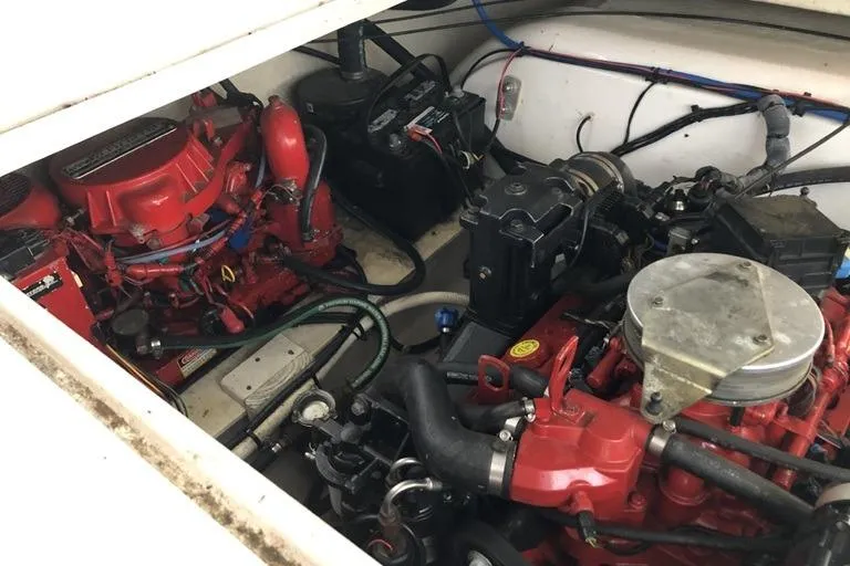 Slide: The Image of Engine compartment of a 2006 Four Winns 258 Vista boat, showcasing red engine components. - 15