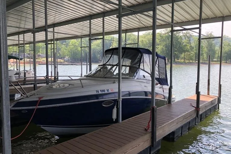 Slide: The Image of 2006 Four Winns 258 Vista boat docked under covered marina. - 2