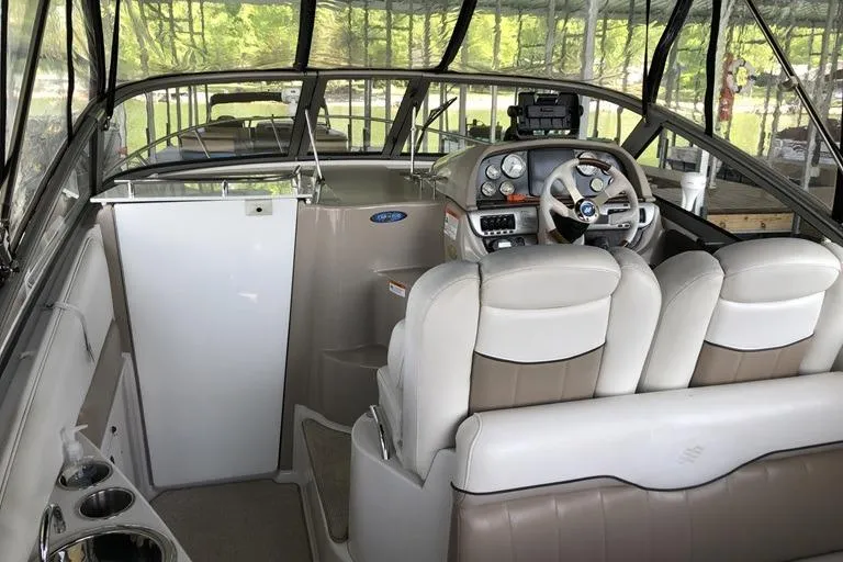 Slide: The Image of Interior of a 2006 Four Winns 258 Vista boat with steering wheel and seating. - 4