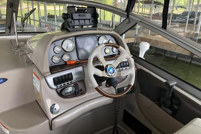 Slide: The Image of 2006 Four Winns 258 Vista boat cockpit with steering wheel and instrument panel. - 6