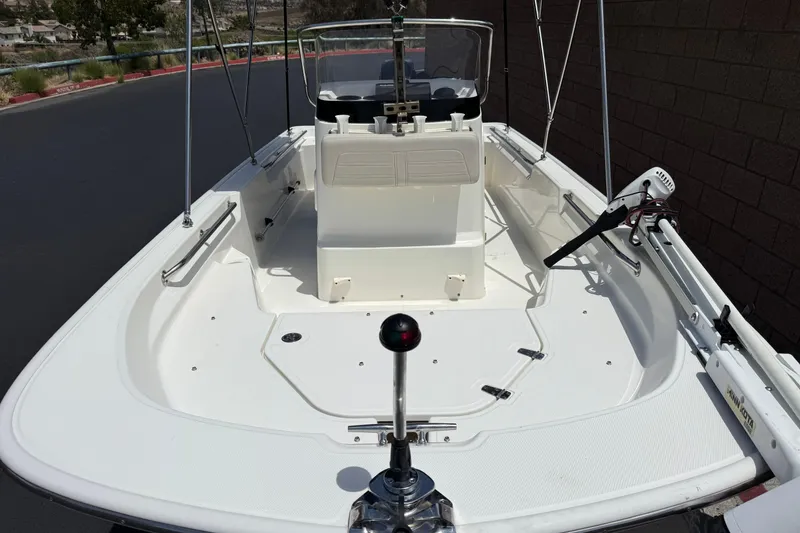 Slide: The Image of 2019 Boston Whaler 150 Montauk boat interior with steering console and seating. - 10