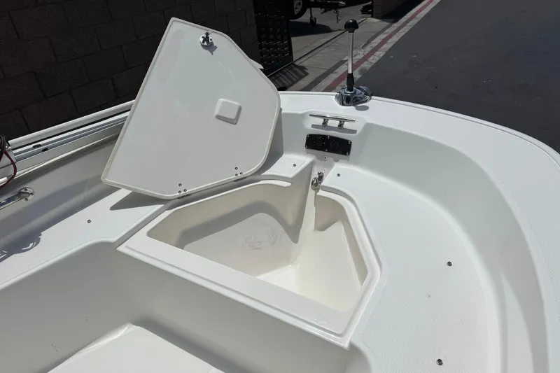 Slide: The Image of 2019 Boston Whaler 150 Montauk boat with open storage compartment. - 12