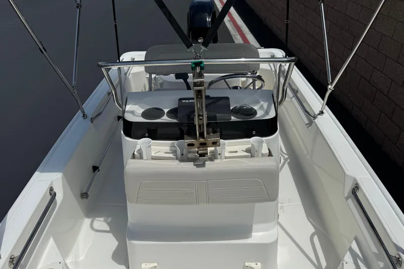Slide: The Image of 2019 Boston Whaler 150 Montauk boat interior with steering console and seating. - 13
