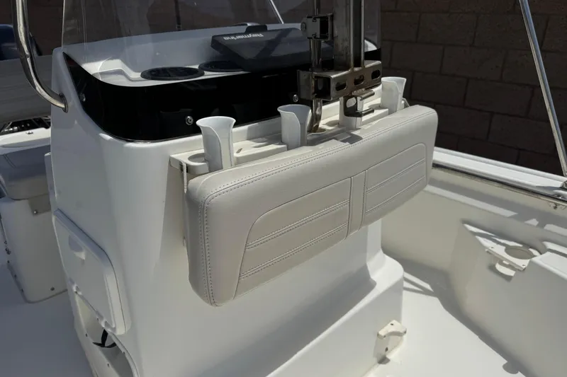Slide: The Image of 2019 Boston Whaler 150 Montauk boat interior with white seating and console. - 14