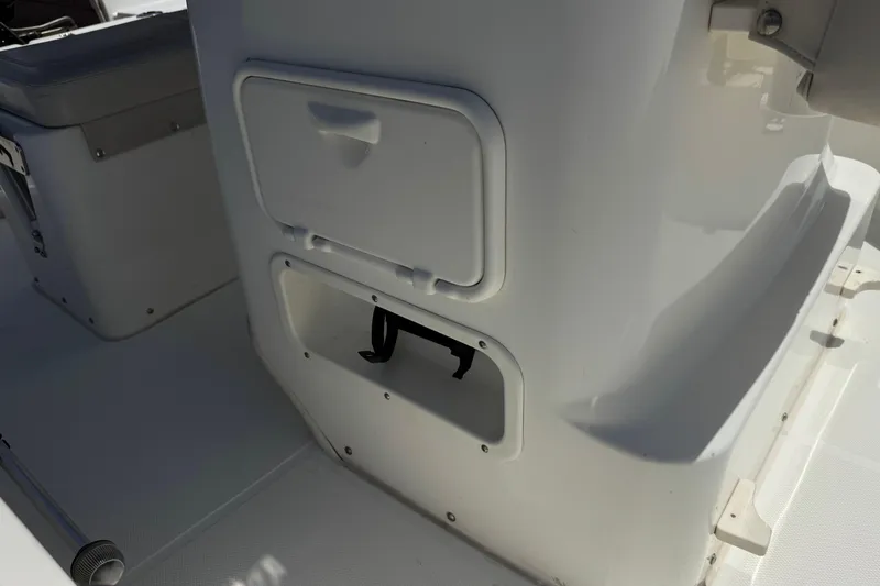 Slide: The Image of 2019 Boston Whaler 150 Montauk boat interior with storage compartments. - 15