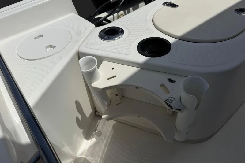 Slide: The Image of 2019 Boston Whaler 150 Montauk boat interior with rod holders and storage compartments. - 17