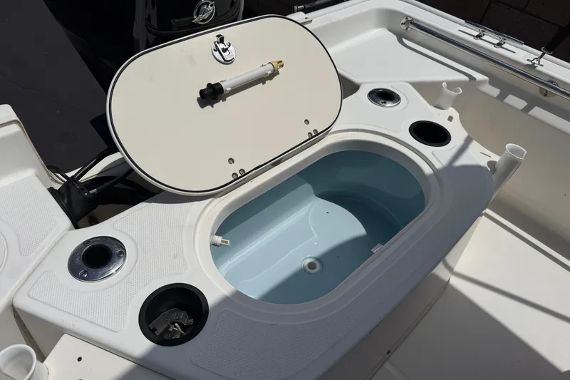 Slide: The Image of 2019 Boston Whaler 150 Montauk boat interior with open storage compartment. - 18