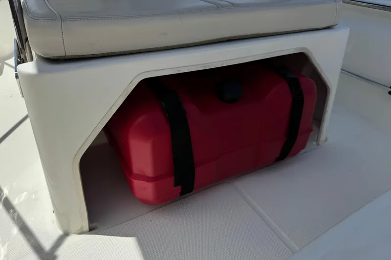 Slide: The Image of 2019 Boston Whaler 150 Montauk boat seat with red fuel tank underneath. - 23