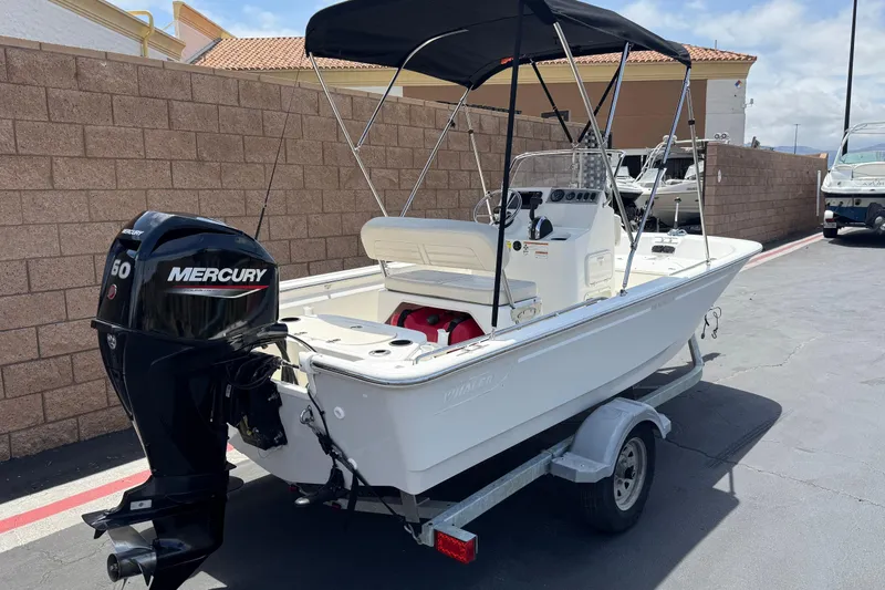 Slide: The Image of 2019 Boston Whaler 150 Montauk boat with Mercury engine on trailer. - 5