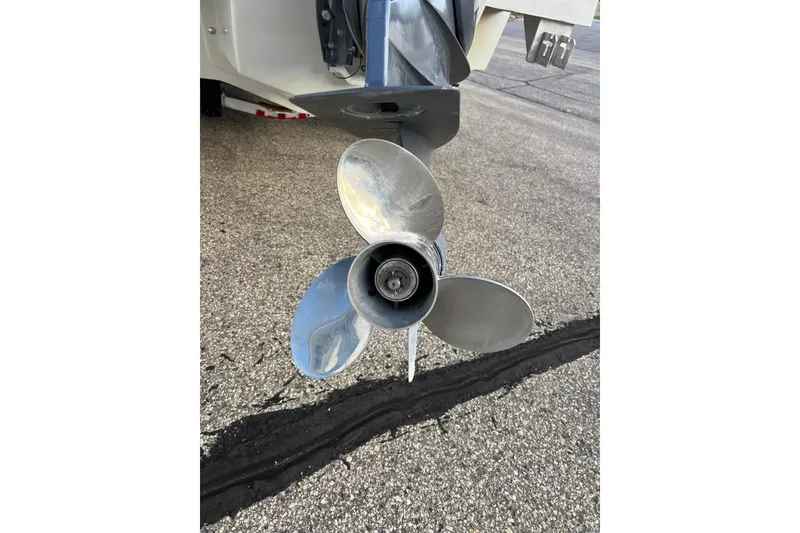 Slide: The Image of Propeller of a 2010 Dusky 256 Center Console boat on pavement. - 10