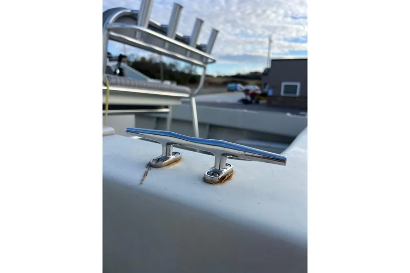 Slide: The Image of 2010 Dusky 256 Center Console boat cleat with rod holders in background. - 12