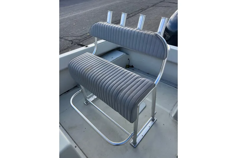 Slide: The Image of Gray cushioned seat with rod holders on a 2010 Dusky 256 Center Console boat. - 14