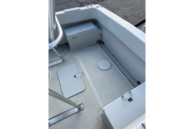 Slide: The Image of 2010 Dusky 256 Center Console boat interior with storage compartments and seating. - 16