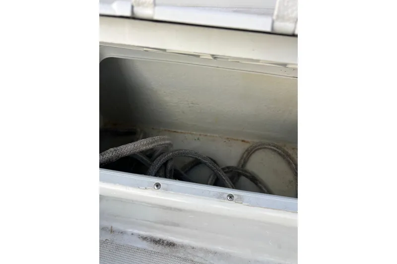 Slide: The Image of Storage compartment with ropes in a 2010 Dusky 256 Center Console boat. - 18