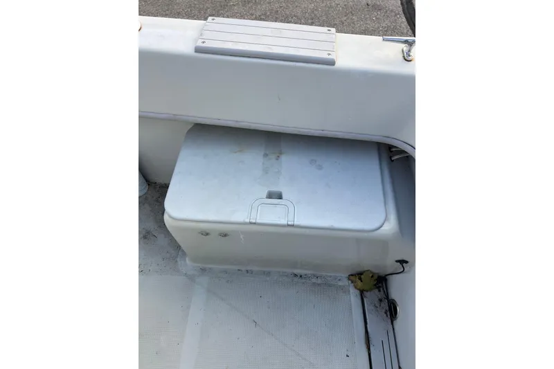 Slide: The Image of Dusky 256 Center Console 2010 boat storage compartment with a closed lid. - 19