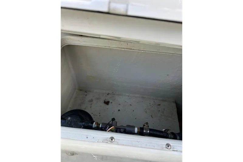 Slide: The Image of Open compartment of 2010 Dusky 256 Center Console boat showing interior details. - 20