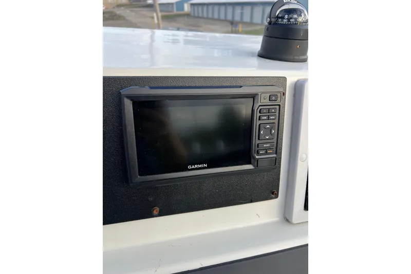 Slide: The Image of Garmin navigation system on 2010 Dusky 256 Center Console boat dashboard. - 24