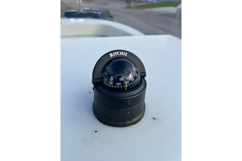 Slide: The Image of Ritchie compass on 2010 Dusky 256 Center Console boat dashboard. - 25