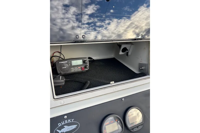 Slide: The Image of Dusky 256 Center Console 2010 with Lowrance marine radio and gauges. - 27