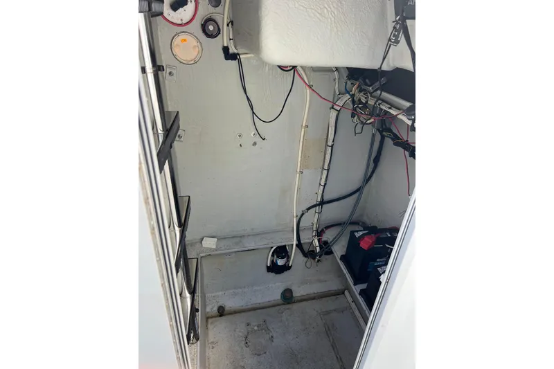Slide: The Image of Interior view of a 2010 Dusky 256 Center Console boat showing wiring and equipment. - 31