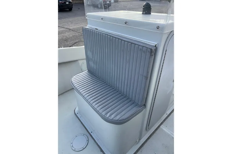 Slide: The Image of Dusky 256 Center Console 2010 boat seat with gray cushioned backrest and base. - 32