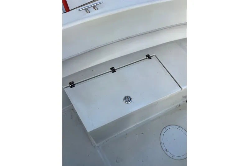 Slide: The Image of 2010 Dusky 256 Center Console boat deck with storage compartment. - 36