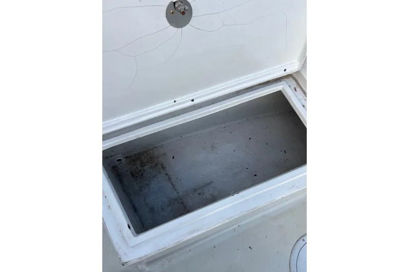 Slide: The Image of Open storage compartment on 2010 Dusky 256 Center Console boat. - 37