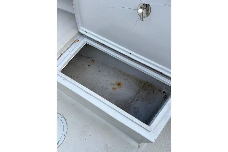 Slide: The Image of Open storage compartment on 2010 Dusky 256 Center Console boat, showing interior condition. - 41