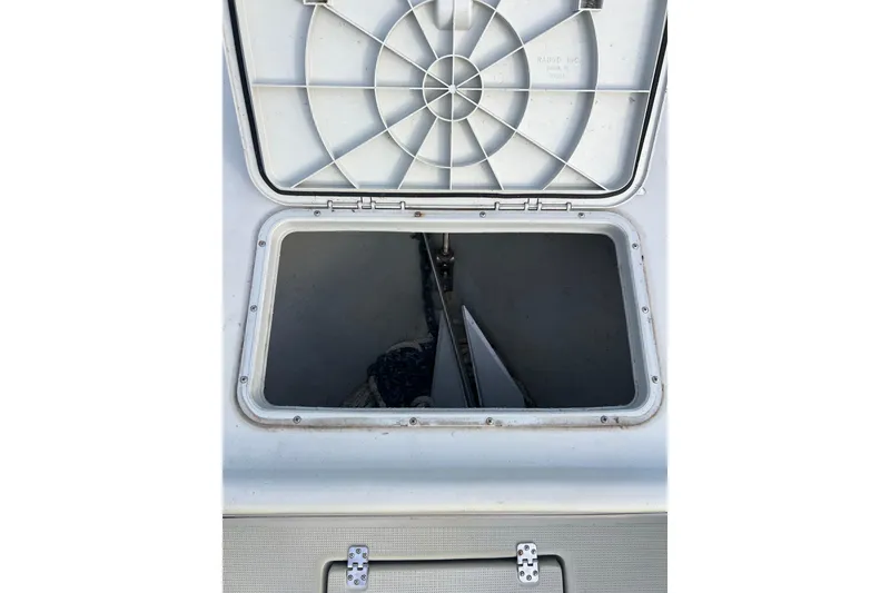 Slide: The Image of Open storage compartment on a 2010 Dusky 256 Center Console boat. - 43