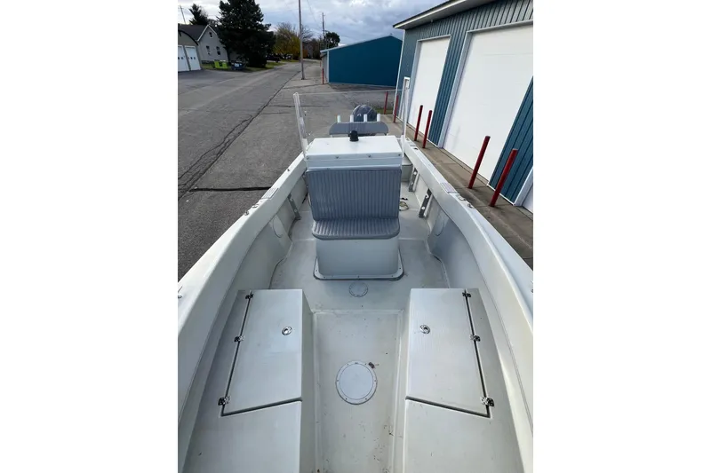 Slide: The Image of 2010 Dusky 256 Center Console boat docked near blue warehouse. - 45