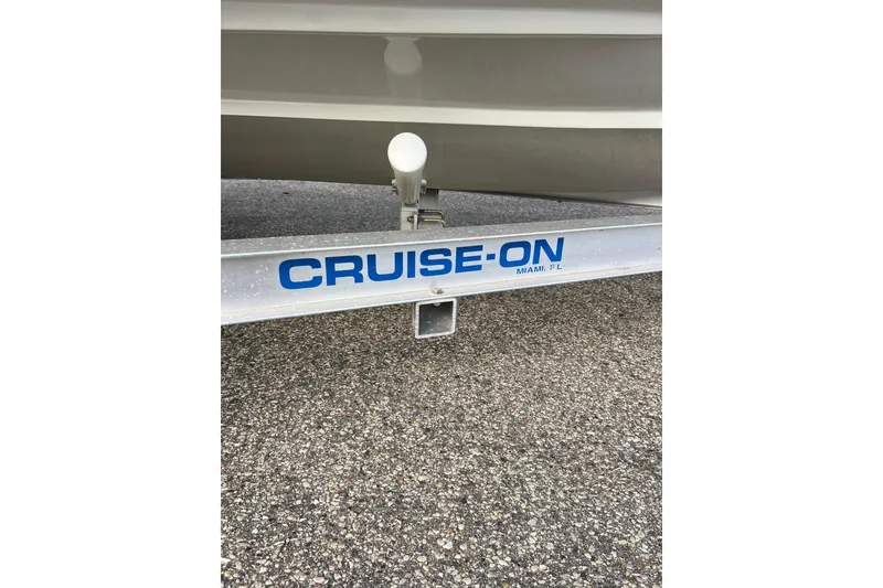 Slide: The Image of Trailer with "CRUISE-ON" branding, supporting a 2010 Dusky 256 Center Console boat. - 5