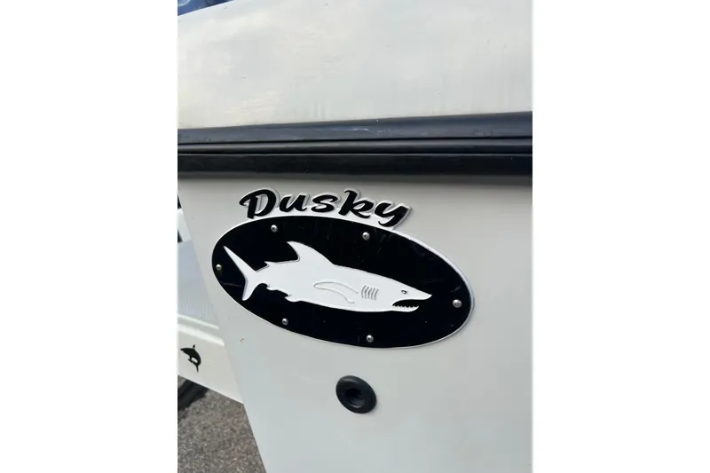 Slide: The Image of Dusky 256 Center Console 2010 boat logo with shark emblem on hull. - 7