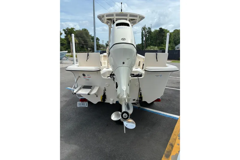 The Image of 2020 Carolina Skiff 23LS boat rear view with outboard motor in parking lot. - 1