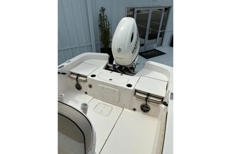 Slide: The Image of 2020 Carolina Skiff 23LS boat with Suzuki outboard motor, featuring spacious deck layout. - 6
