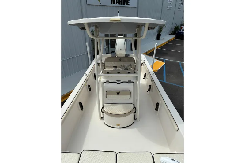 Slide: The Image of 2020 Carolina Skiff 23LS boat interior with seating and console, parked at a marina. - 7