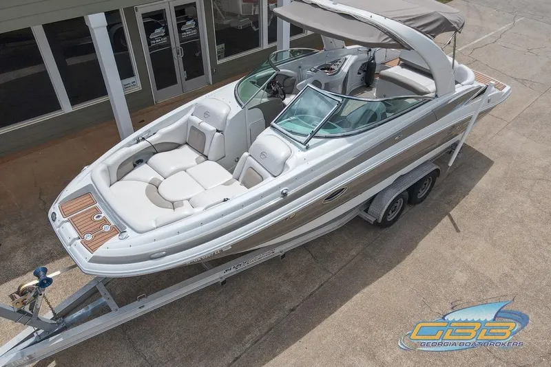 The Image of 2015 Crownline Eclipse E6 boat on trailer, parked outside a building. - 0